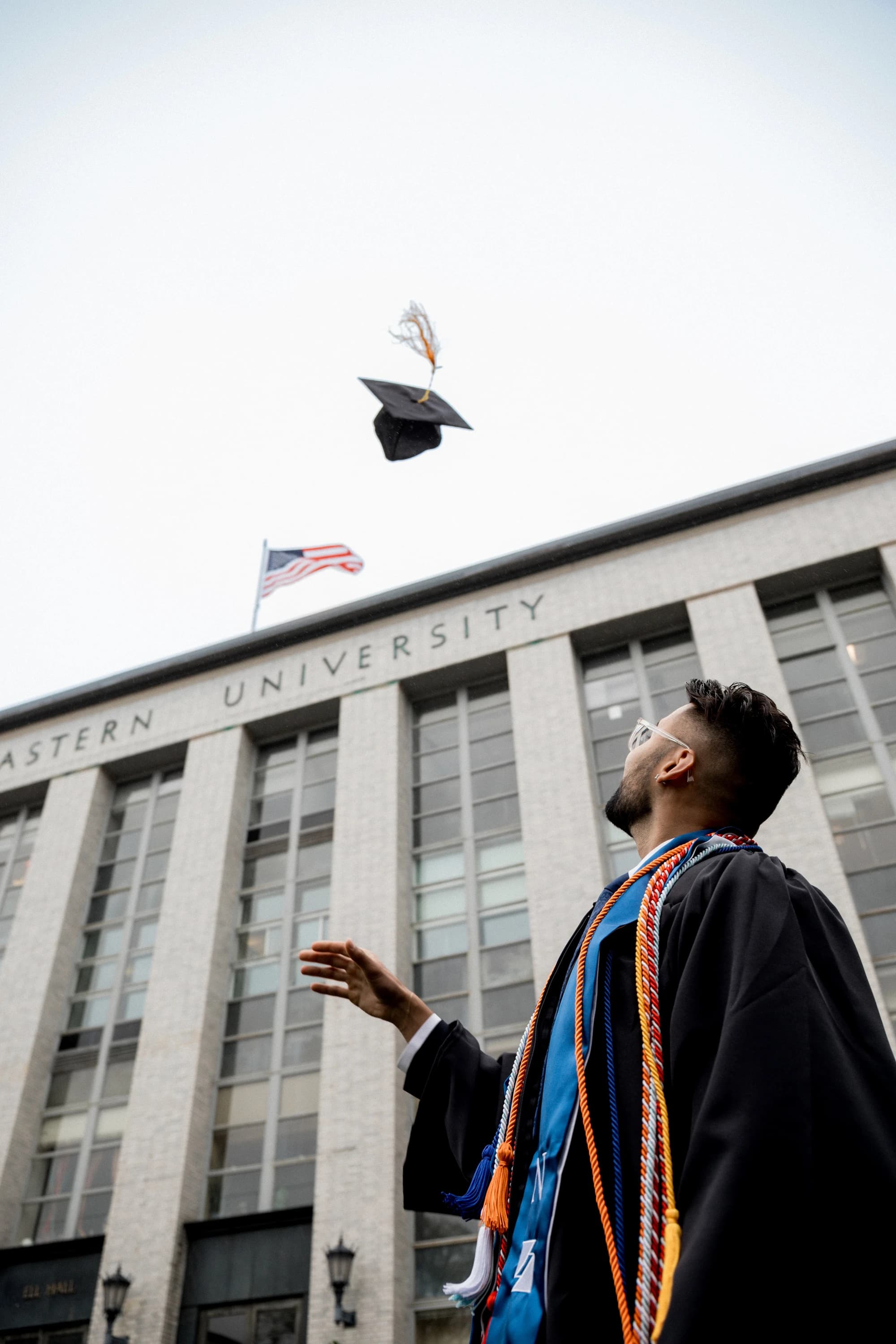 Chirag Chadha tossing graduation cap at Northeastern University